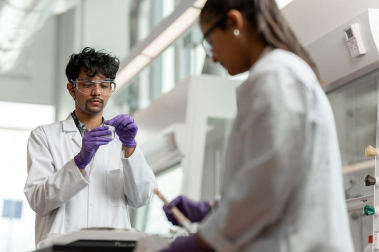 Two students performing experiments in a laboratory on U of T campus