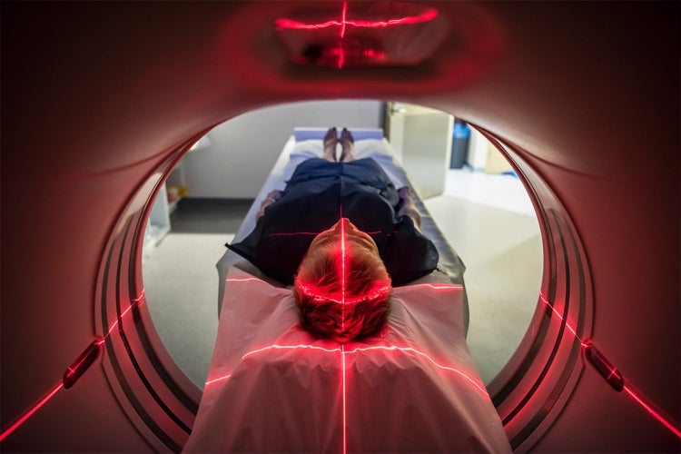 A man is receiving a CAT scan