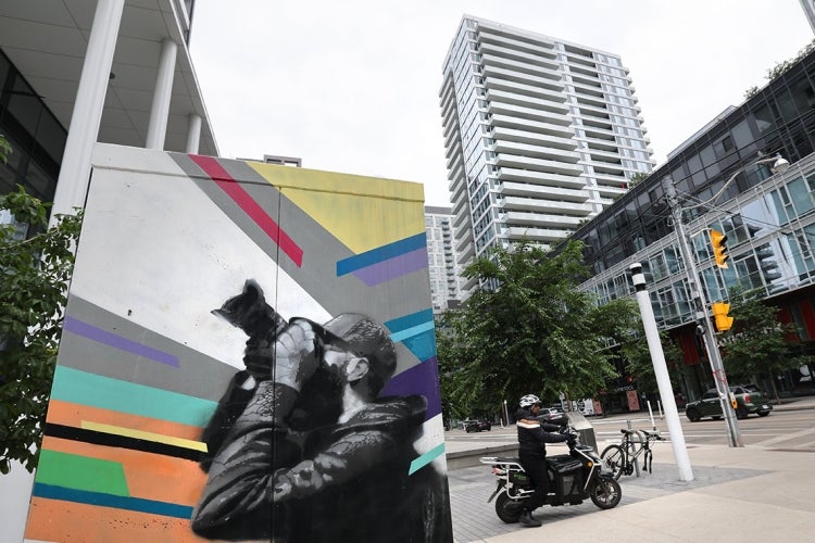 Regent park neighbourhood in downtown Toronto with public art in the foreground