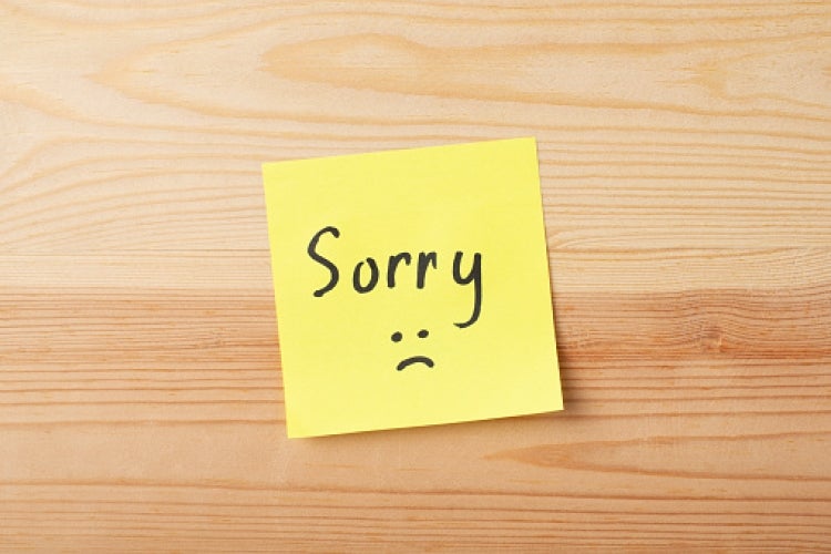 word "sorry" written on a sticky note