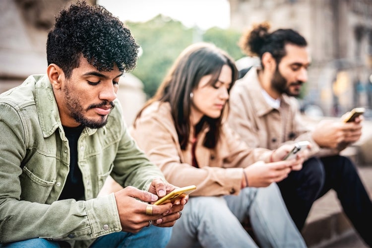 group of university students on mobile devices