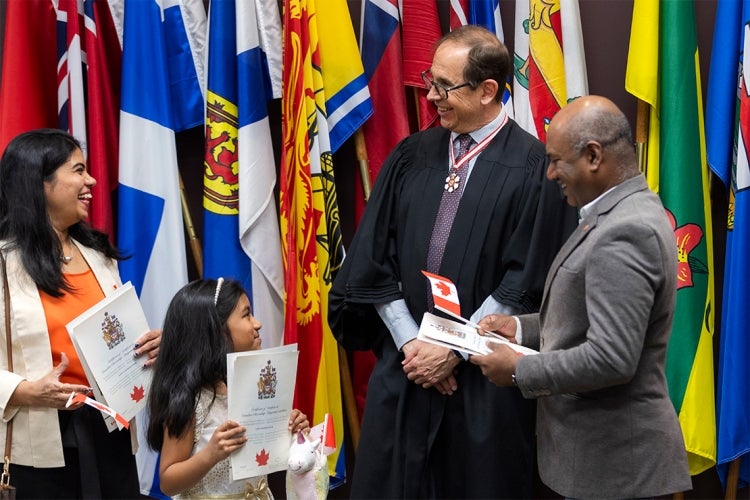 Mark Lautens laughs with some new Canadian citizens