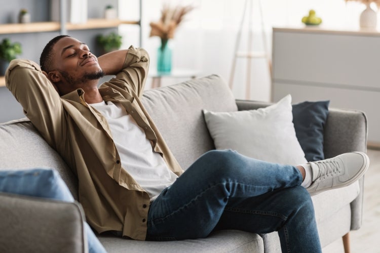 man relaxing on a sofa at home