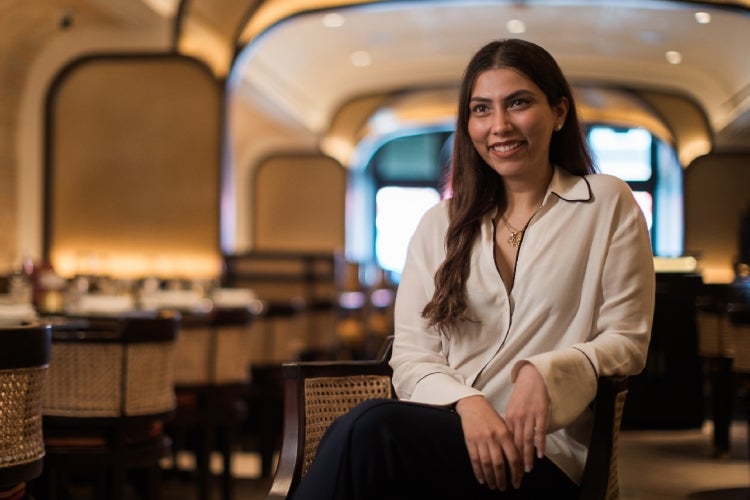 Ambica Jain is seated at one of her restaurants