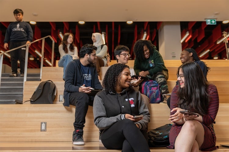 student sit on steps at the Krembil Student Commons at Highland Hall, UTSC