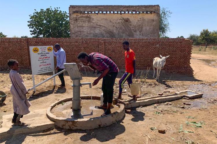 A man drinks from a well in Sudan