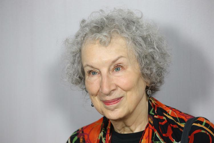 Portrait of Margaret Atwood in front of a grey wall