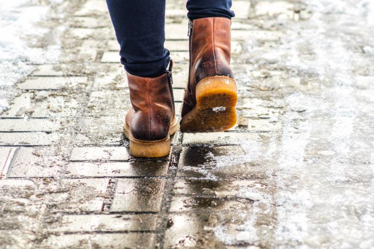 Man walking on icy sidewalk