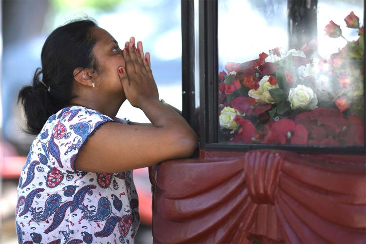 Woman praying after Sri Lanka attack