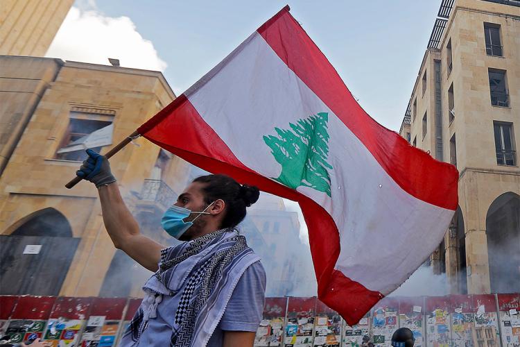 protestor waving a lebanese flag in beirut