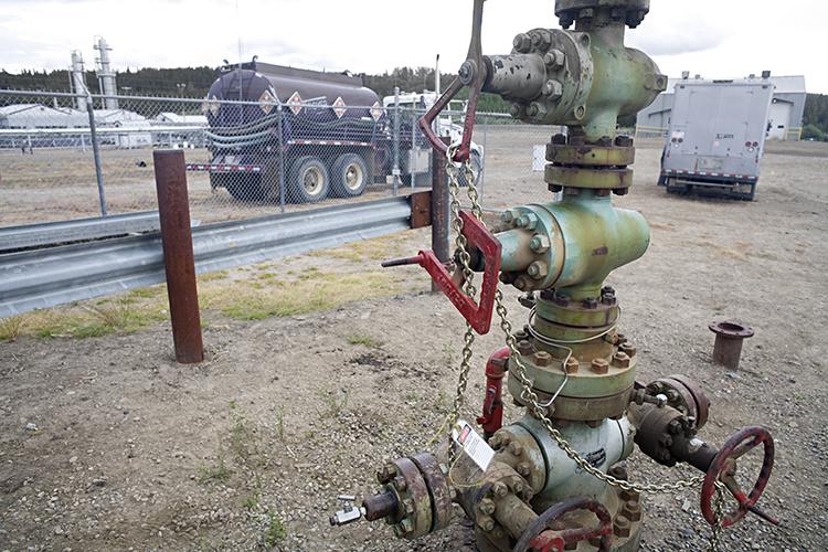 Chained up natural gas wellhead with valves, Northern British Columbia, Canada.