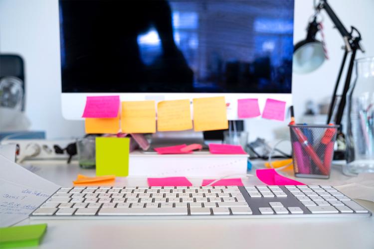 desktop computer monitor covered in post it notes