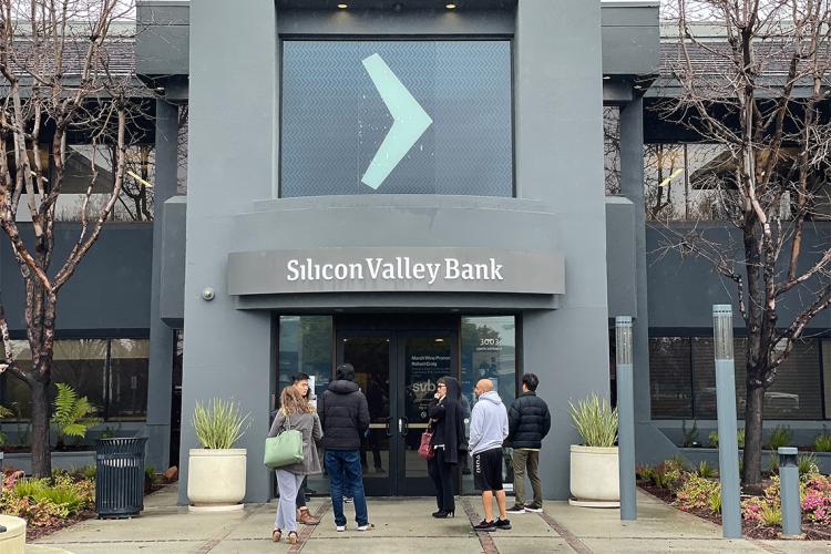 people wait outside a branch of Silicon Valley Bank