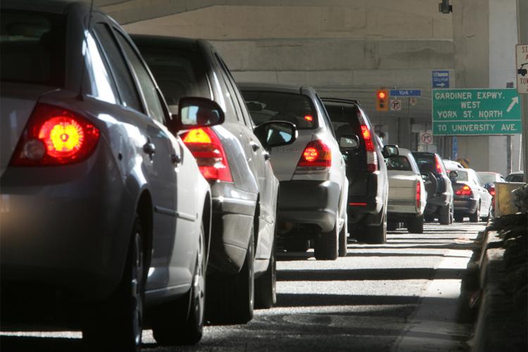 A long line of idling cars on a Toronto street