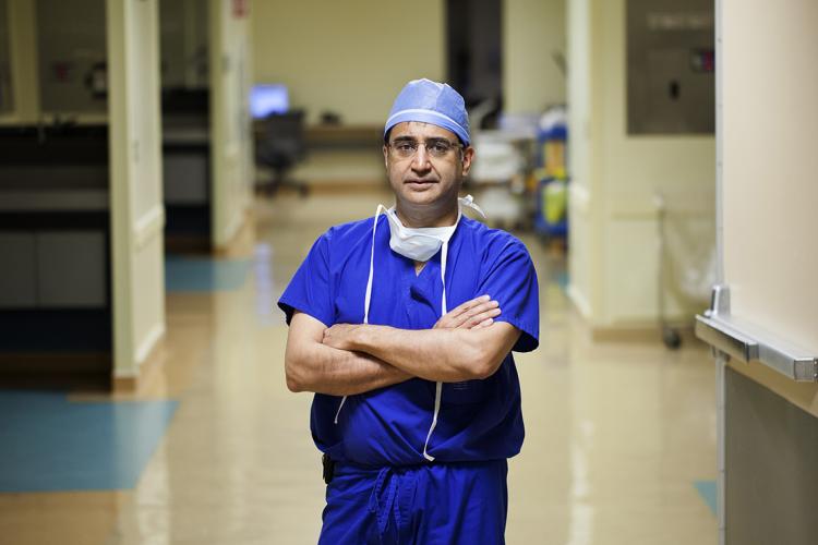 Shaf Keshavjee in a hospital hallway in surgical scrubs