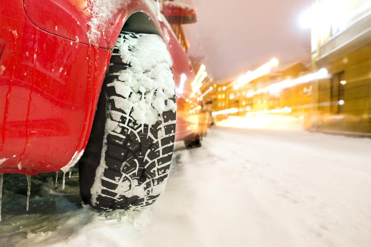 close up of a car tire on a snowy road