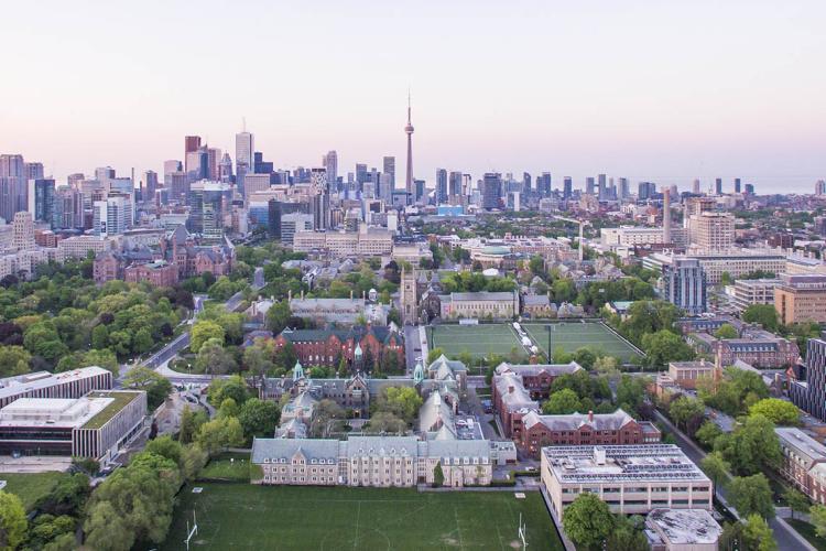 Aerial view of U of T downtown campus bathed in a rosy glow from the sun rising
