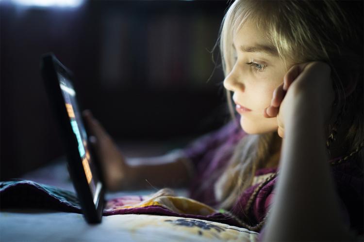 Photo of a teen looking at an iPad