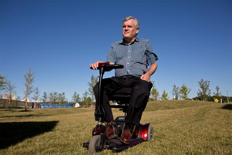 David Onley sit atop a mobility device