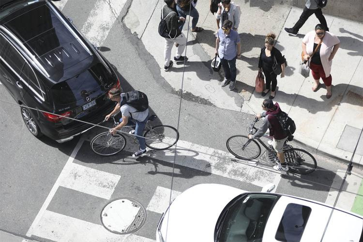 overhead view of toronto cyclists dodging cars at an intersection