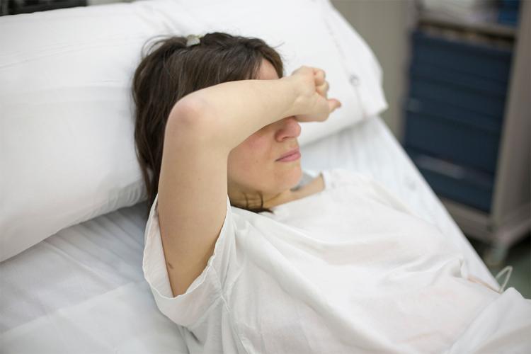 photo of woman in a hospital bed