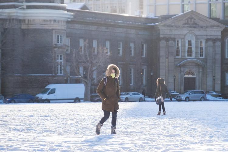 Student walking across front campus