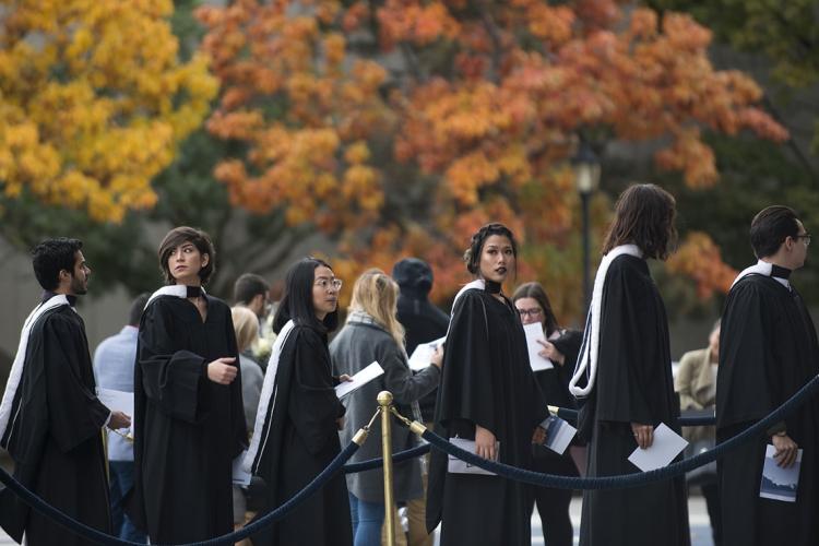 Photo of grads and fall trees