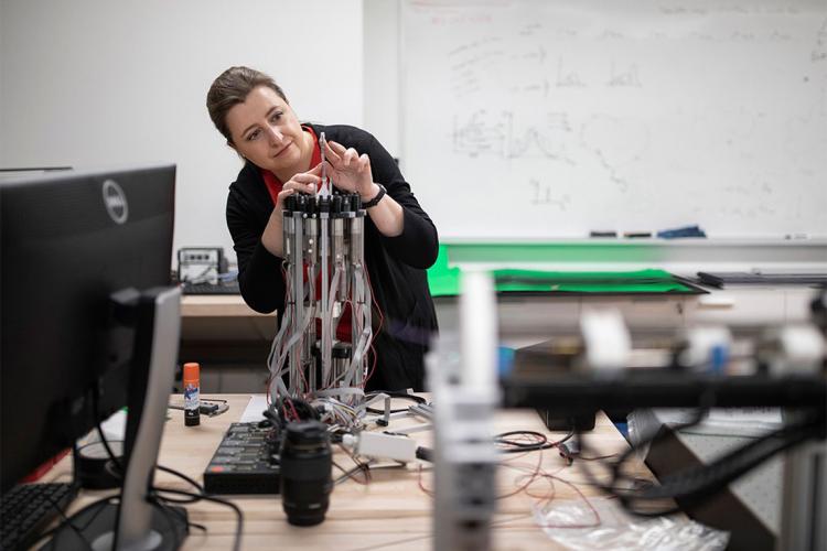 Jessica burgner-Kahrs works on a robot in her lab