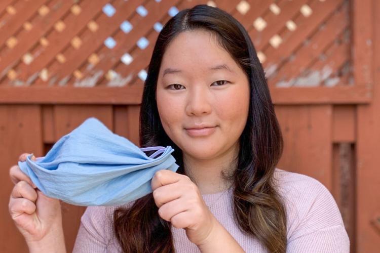 Portrait of Calandra Li holding up a homemade mask