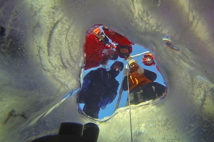 photo of camera being lowered below ice