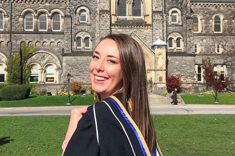 Portrait of Maureen Gustafson in her graduation robes in front of University College