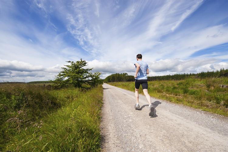 Photo of a jogger on a trail