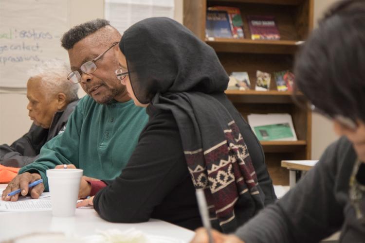 Instructor and students at a writing workshop