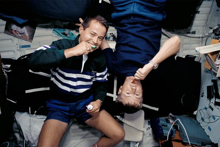 Astronauts brushing their teeth on the Space Shuttle Discovery