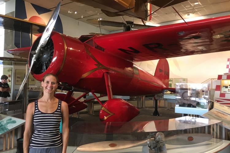 Lindsay Zier-Vogel stands in front of Amelia Earhart's plane at the Smithsonian