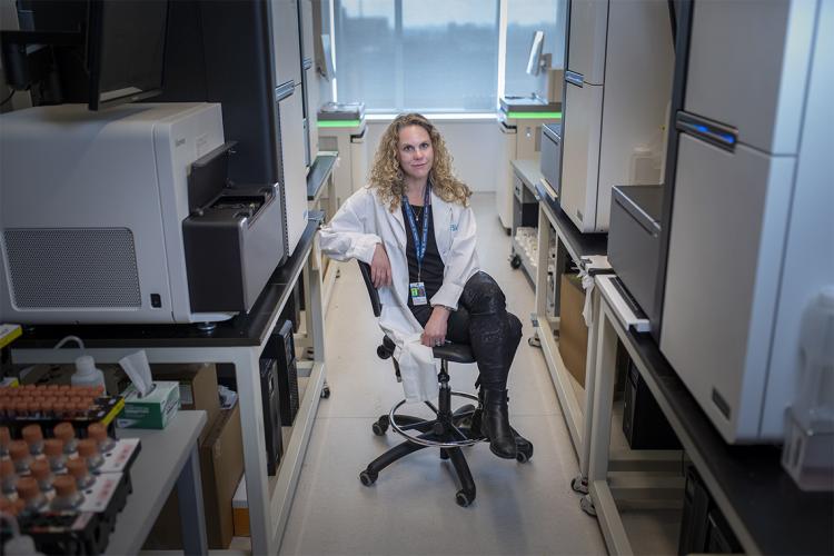 Lisa Strug sits on a chair in a hallway