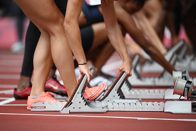 Runners line up in the starting block at the Tokyo Games