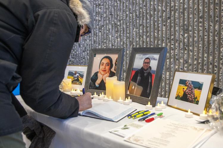 Mourner signs a book of condolences at a vigil for the victims of Flight 752