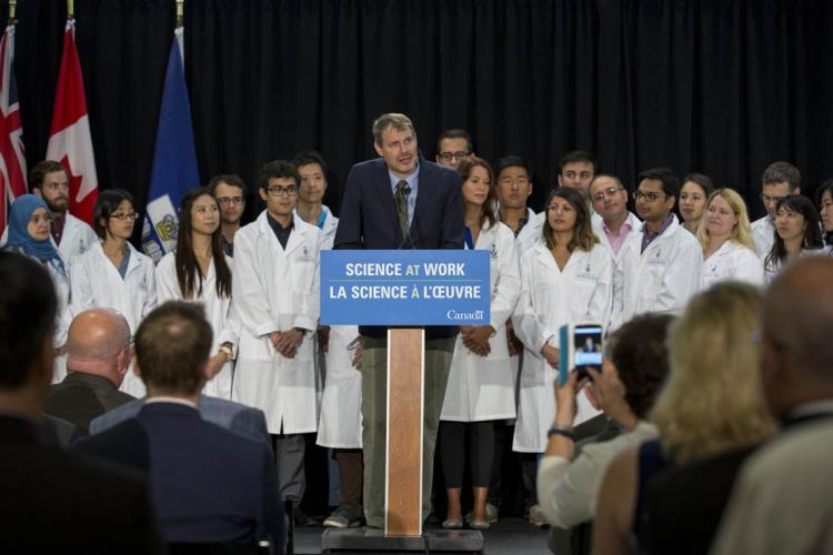 Peter Zandstra stands at the podium in front of a group of researchers at the CFREF funding announcement