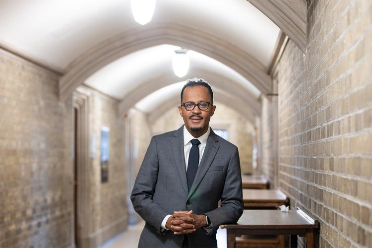 Social Work Dean Dexter Voisin stands in a hallway