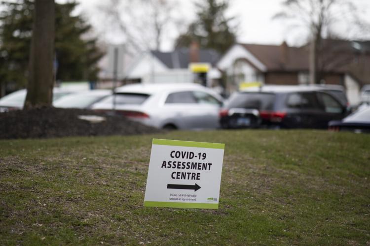 A sign indicates the direction to a COVID-19 assessment centre