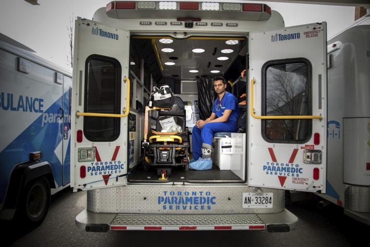 Sameer Masood sits inside an ambulance