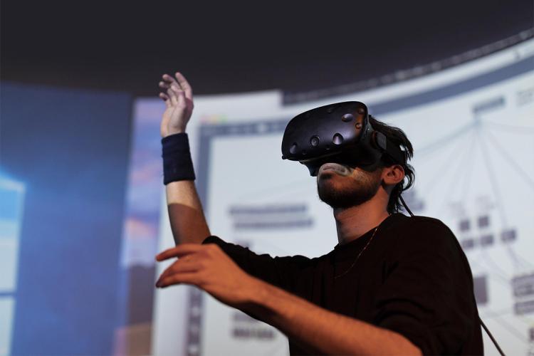 A man using VR goggles in a darkened room