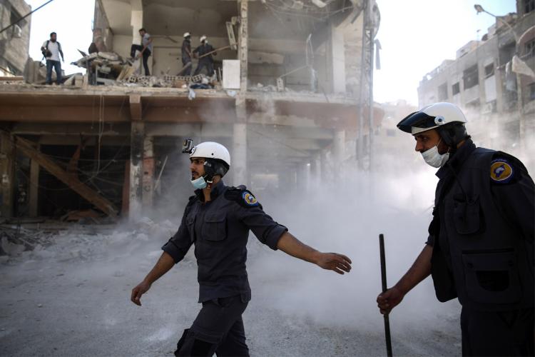 photo of White Helmets in the city of Douma following air strikes