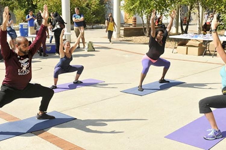 People doing yoga outside