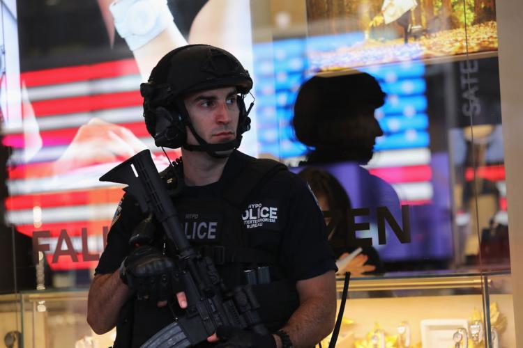 Heavily armed policeman stands on guard in Times Square