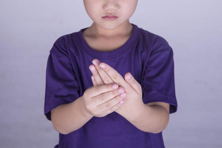 photo of boy grasping fingers