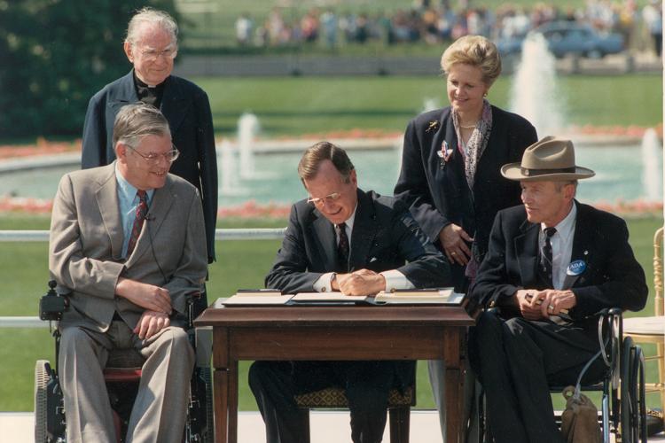 George H.W. Bush signing the Americans with Disabilities Act 