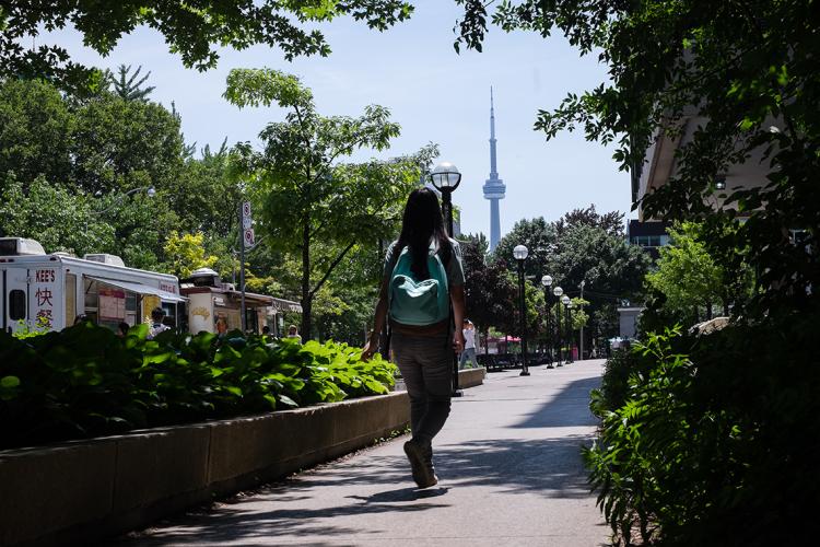 Student walking through downtown campus