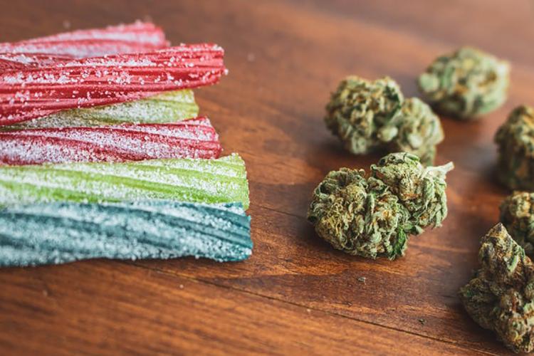 Photo of cannabis candy and cannabis buds sitting on a table